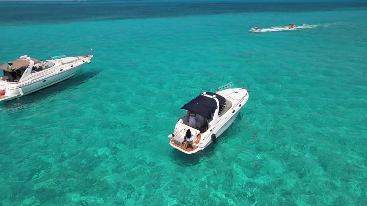 Yachts cruising through the clear water guests come to Cancún for